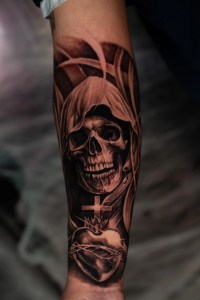 Black and grey realism tattoo of a grim reaper and sacred heart by Monochrome Tattoo Studio in Fresno, CA.